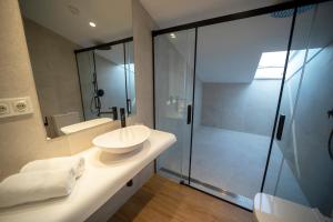 a bathroom with a sink and a glass shower at Hotel Boutique Berazadi Berri in Zarautz