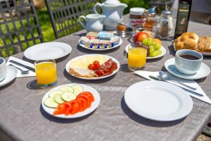 a table with plates of food and fruit on it at B&B Marijana in Malinska