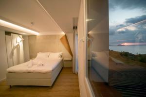 a bedroom with a bed and a view of the ocean at Hotel Boutique Berazadi Berri in Zarautz