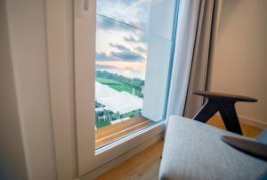 a room with a window with a view of a balcony at Hotel Boutique Berazadi Berri in Zarautz