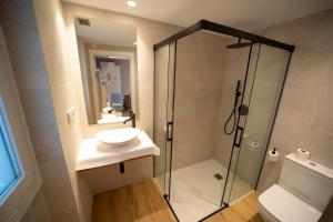 a bathroom with a shower with a sink and a toilet at Hotel Boutique Berazadi Berri in Zarautz