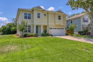 a house with a green lawn at Relax in Jax in Jacksonville Beach