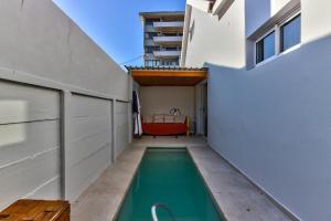 a swimming pool in the courtyard of a house at SASHORES- 6 on Ellis in Cape Town