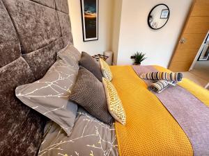 a bed with pillows on top of it at The Duplex with Air Conditioning & Private Deck Area in Margate