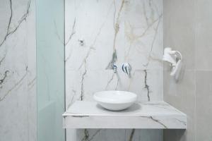 a bathroom with a white bowl on a counter at Onar in Skala Marion +36 photos