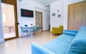 a living room with a blue couch and a table at Petite palace in Rethymno Town