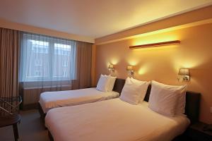 Postel nebo postele na pokoji v ubytování Hotel Uilenspiegel