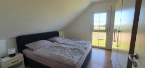 a small bedroom with a bed and a window at top Haus 160m2 Europapark,Strasburg,Schwarzwald in Appenweier
