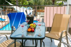 a blue table with wine glasses and fruit on it at Fitosinn Hotel in Paphos