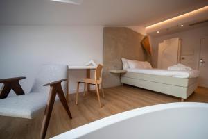 a small room with a bed and a desk at Hotel Boutique Berazadi Berri in Zarautz