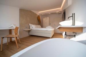 a small bathroom with a bed and a sink at Hotel Boutique Berazadi Berri in Zarautz