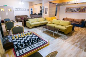 a living room with a chess board in the middle at Fitosinn Hotel in Paphos