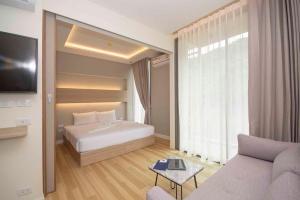 a hotel room with a bed and a couch at Apartment in Aonang - great location with pool in Ao Nang Beach +27 photos