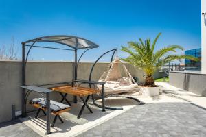 a table and chairs on a patio with a tent at PS Apartments in Pula