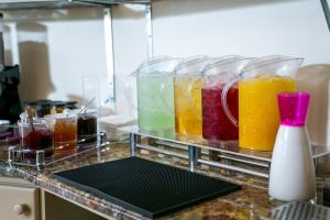 a bunch of different colored liquids in glass containers on a counter at Fitosinn Hotel in Paphos