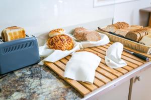a tray of bread and other foods on a counter at Fitosinn Hotel in Paphos
