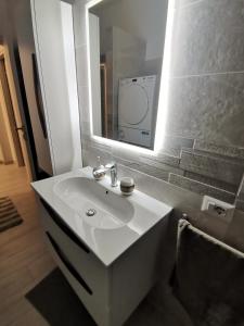 a bathroom with a white sink and a mirror at Shining house in Milan in Milan +22 photos