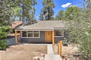 a small house with a garage at Big Bear Cabin with Deck and Hot Tub Near Resorts! in Big Bear Lake