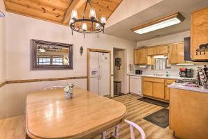 a kitchen with a wooden table in a room at Hot Tub and Deck Big Bear Gem Near Resorts! in Big Bear Lake