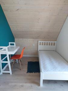 Łóżko lub łóżka w pokoju w obiekcie Jantarovnia