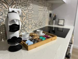 a coffee machine sitting on a counter next to a tray of pastries at alisios loft in Las Palmas de Gran Canaria