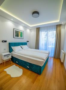 a bedroom with a large bed and a window at Kedar apartment in Novi Sad