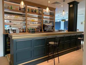 a blue bar with stools in a restaurant at LE PATIO in Millau +73 photos