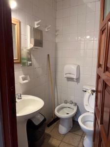 a bathroom with a sink and a toilet at Ferienhaus Hostel Salta in Salta