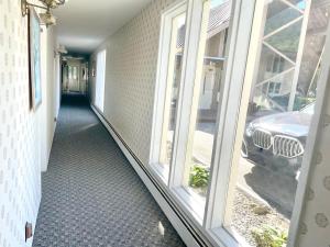 a hallway of a house with two windows at Toll Road Inn in Manchester