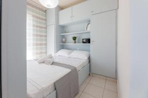a small bedroom with a bed and a window at Loutraki Getaway - Cozy and Quiet Nest in Loutraki +35 photos