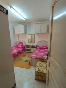 a room with two beds and a door open at Rivera Beach 1 - Ras Sedr in Ras Sedr