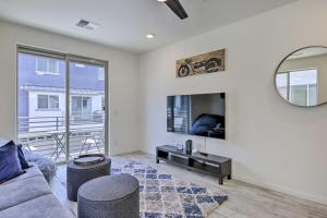 a living room with a couch and a mirror at Executive Chandler Townhome with Community Perks in Chandler