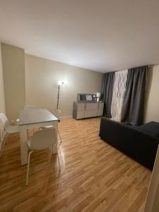 a living room with a table and a couch at Studio aux portes de Paris in Chatou
