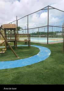 a park with a playground with a slide at MURO ALTO COND CLUBE Bl4 413 in Ipojuca