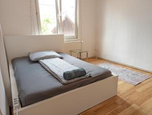 a bed in a room with a large window at 6 people Vacation Apartment In The Black Forest in Villingen-Schwenningen
