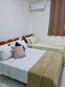 Tempat tidur dalam kamar di Angra Inn - Praia Grande 318