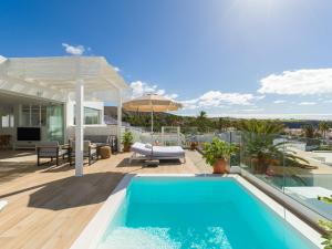 a house with a swimming pool and a patio at Pasitoblanco Porto Mare 7 Seaview Villa private heated pool in Pasito Blanco