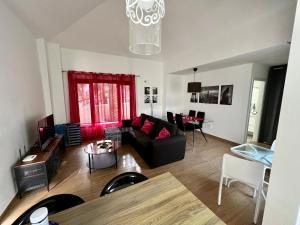 a living room with a couch and a table at Bungalow Nueva York in Costa Teguise