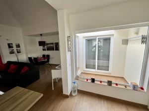 a living room with a large window and a couch at Bungalow Nueva York in Costa Teguise