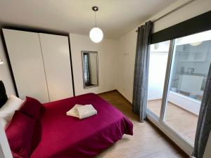 a bedroom with a red bed and a large window at Bungalow Nueva York in Costa Teguise +38 photos