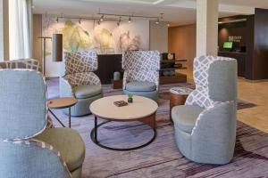 a waiting room with chairs and a table at Sonesta Select Indianapolis Carmel in Carmel