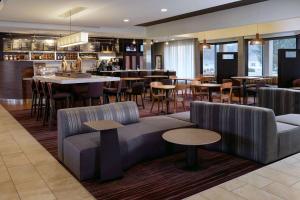 a restaurant with couches and tables and a bar at Sonesta Select Kansas City South Overland Park in Kansas City