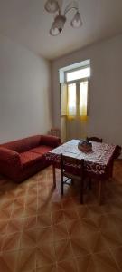 a living room with a couch and a table at Casa Vacanza alloggio Casa Maria in Sennori +14 photos