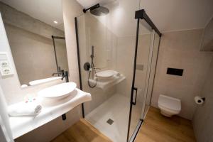 a bathroom with a toilet and a sink and a shower at Hotel Boutique Berazadi Berri in Zarautz
