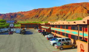 a parking lot with cars parked in front of a motel at Big Horn Lodge in Moab +43 photos