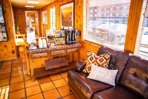 a living room with a leather couch in a store at Big Horn Lodge in Moab