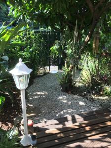a garden with a light in the middle of a pathway at T1 bis verdoyant in Cayenne