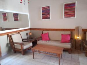 a living room with a couch and a table and chairs at Ferienhaus Hostel Salta in Salta