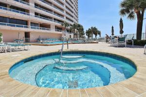 a large swimming pool in the middle of a resort at Crescent Beach Club I 5C in Clearwater Beach