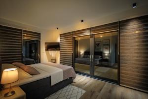 a bedroom with a bed and a glass wall at Villa Hedona in Komarna +78 photos